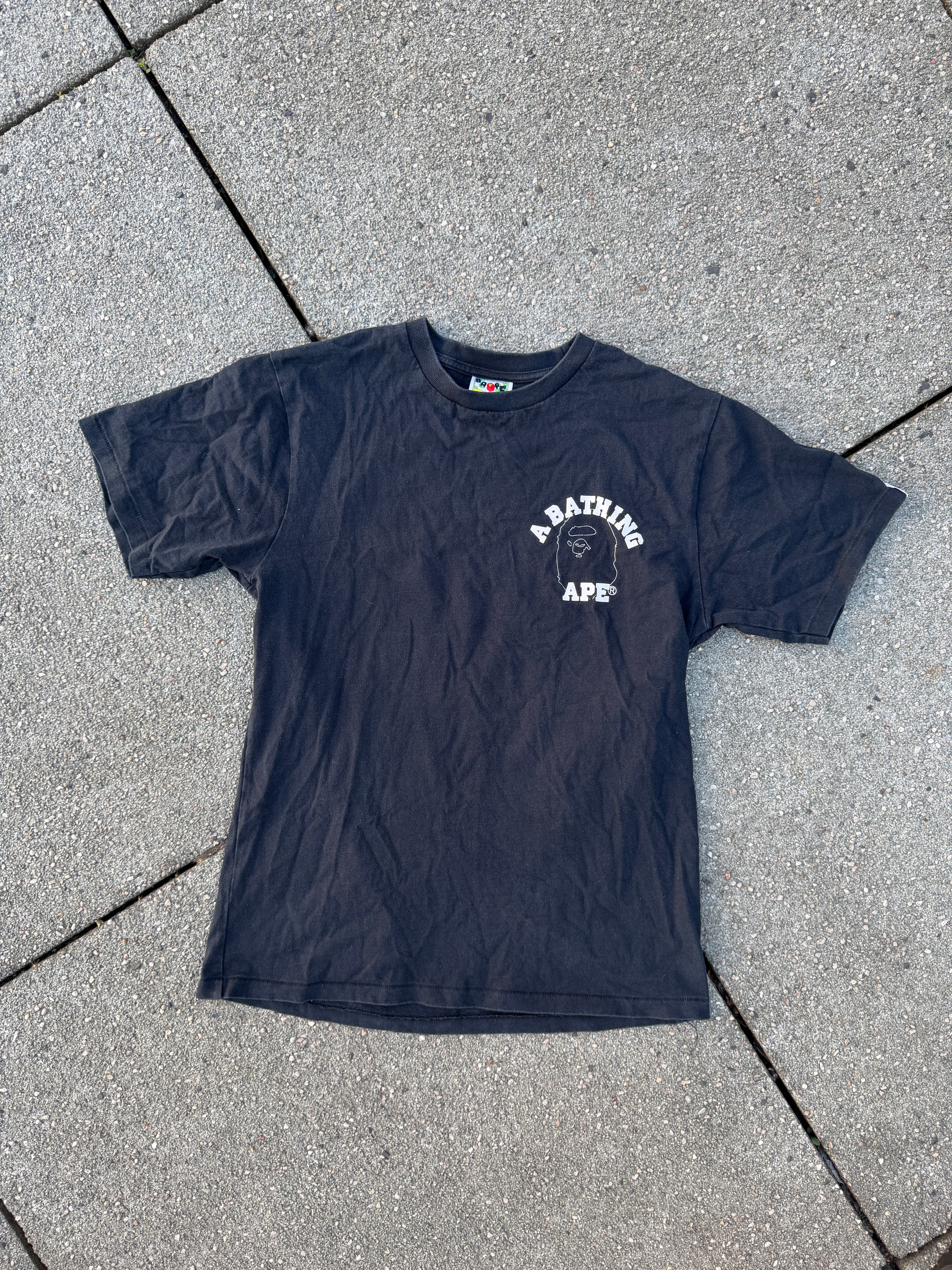 A BATHING APE – 1st Camo Face Over College Tee (Black)